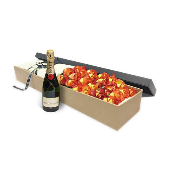 A box of luxury orange roses and a bottle of Veuve Cliquot champagne